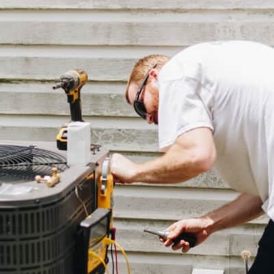 Hvac Technician Working On Unit